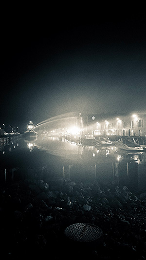 water cannons firing from a ship onto the warehouse building at 481 van brunt street in red hook
